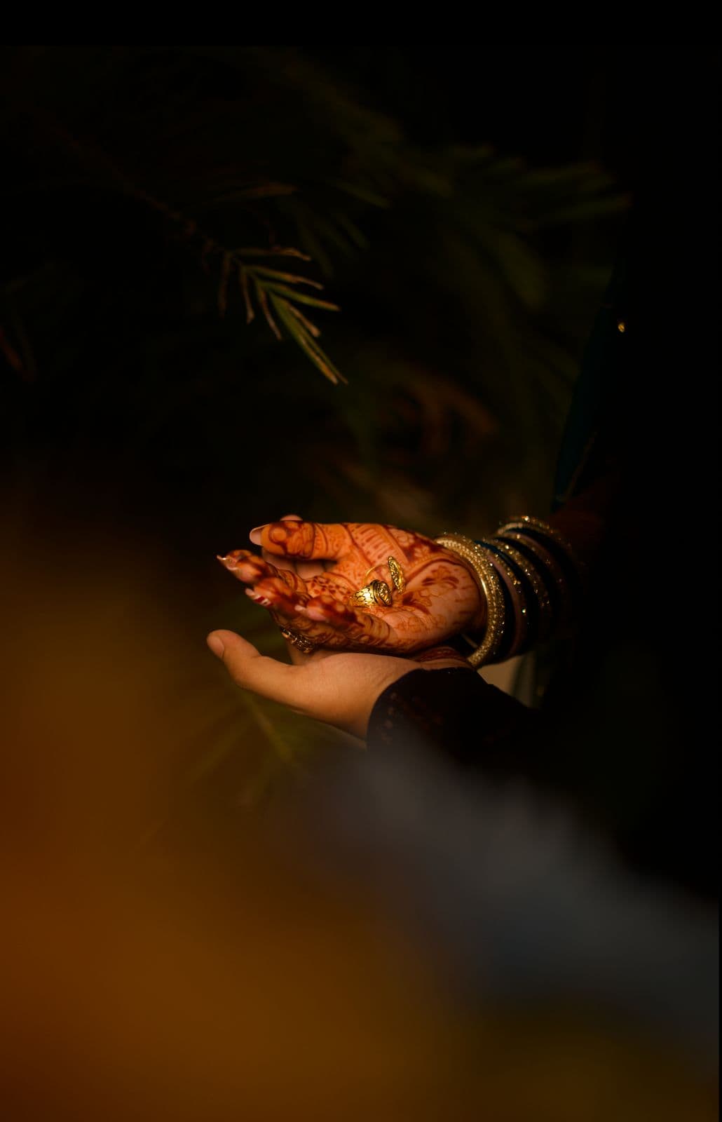 Bridal mehndi hand with wedding ring — detail shot